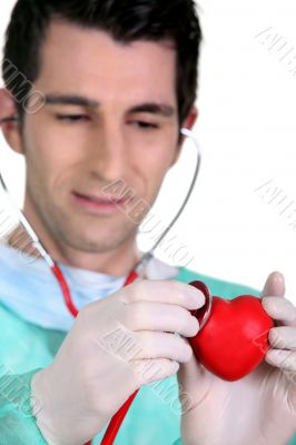 Doctor listening to the heartbeat of a heart