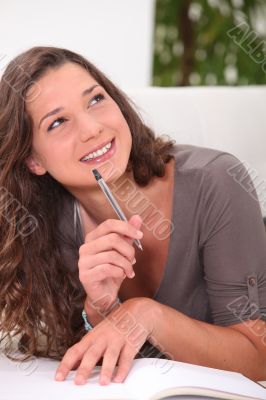 Woman wondering what to write in her book