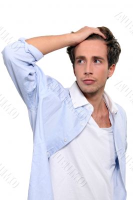 Young man running his hand through his hair
