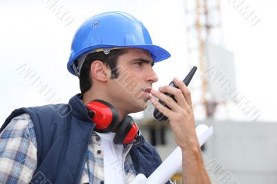 A foreman giving instructions through his cb.