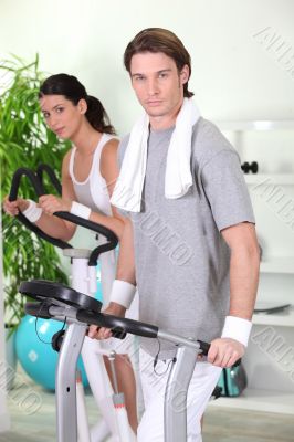 Man and woman working out in a gym