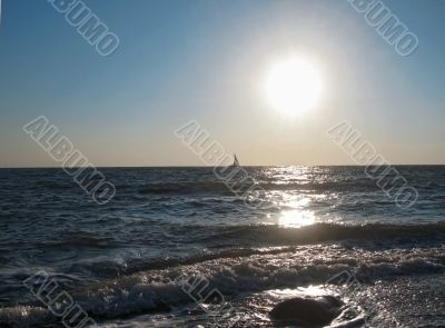 Lonely sail drifting under the big sun