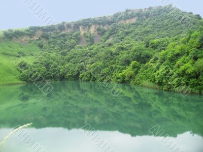 Small lake between the caucasus mountains summertime