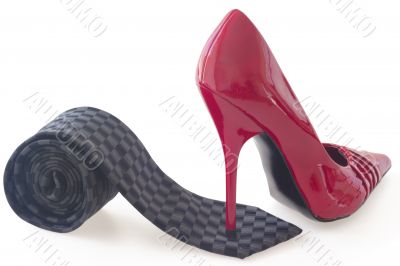Red shoe on black tie on white background