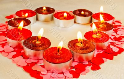 Many burning candles in a form of heart  