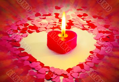 Burning red heart shaped candle