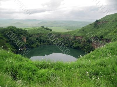 Small lake between the caucasus mountains summertime