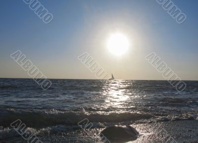 Lonely sail drifting under the big sun