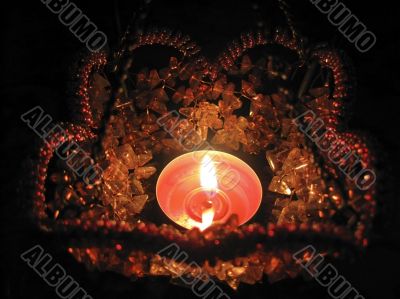 Flaming candle in basket and dark background