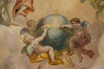 Three little angels holding the globe