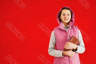 Teen girl staying with a book