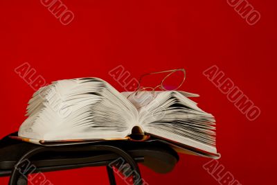 Open book laying on the chair 