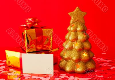 Two presents, blank card and golden evergreen tree