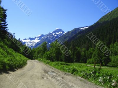 Road leads close to the snowy mountain