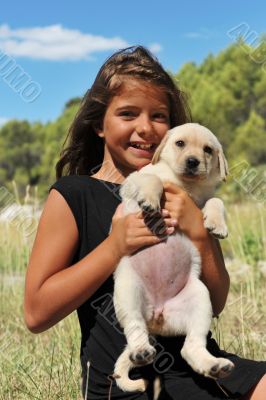 puppy labrador and smiling girl