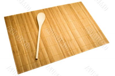 Wooden spoon on mat of bamboo