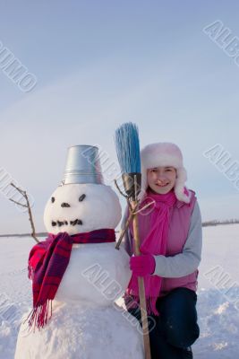 Teenage girl with snowman