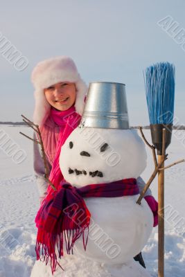Teenage girl with snowman