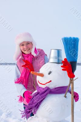 Teenage girl with snowman