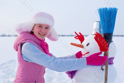 Teenage girl with snowman