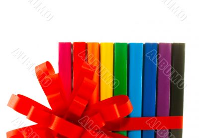 Row of colorful books tied up with ribbon