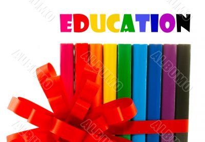 Row of colorful books tied up with ribbon