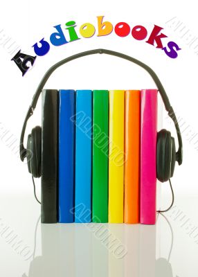 Row of books and headphones - Audiobooks concept