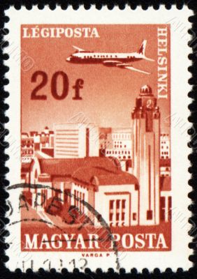Flying plane above the Helsinki on post stamp