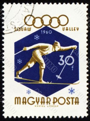 Running skier on post stamp