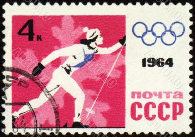 Running skier on post stamp