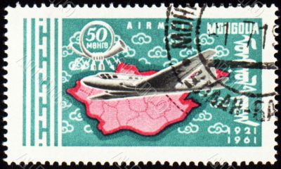 Flying air liner and map of Mongolia on post stamp