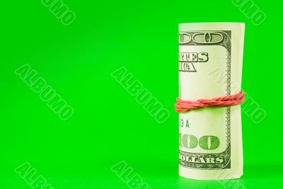 Roll of US dollars tied up with rubber