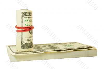 Roll of US dollars tied up with rubber on the stack of bills