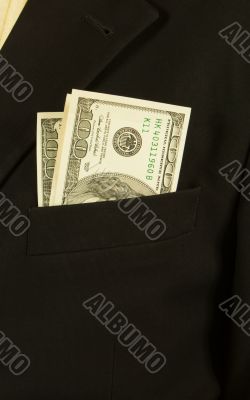 Close-up of businessman with dollar banknotes in pocket