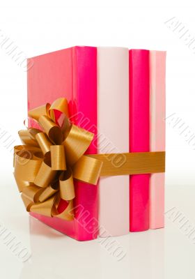 Four books tied up with ribbon