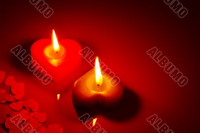 Two burning heart shaped candle