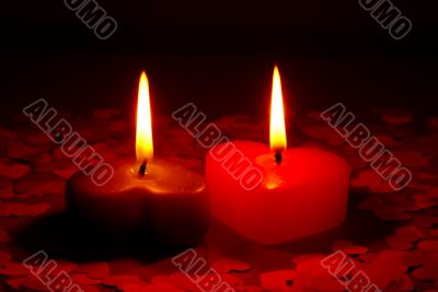 Two burning heart shaped candle