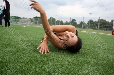 woman lying on the football field edge