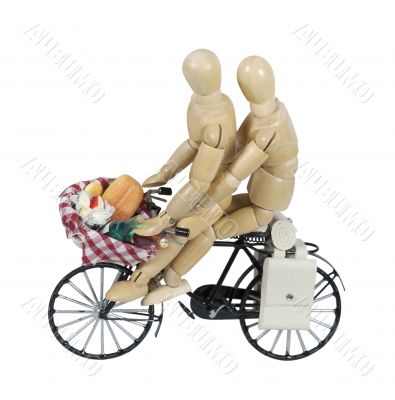 Two on a Bike with a Picnic in a Basket