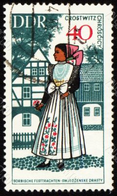 Young woman in national costume on post stamp