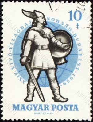 Ancient warrior with sword on post stamp