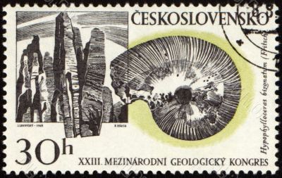 Mountains and fossil on post stamp