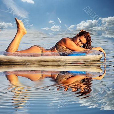 sexy woman with an air mattress in the water