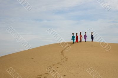 Walking women on sand