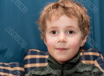 Boy smiles and looks