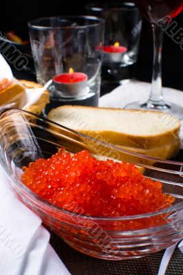 Red caviar in a glass plate 