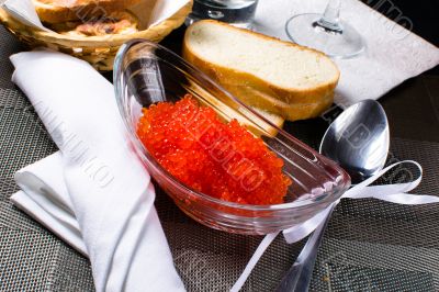 Red caviar in a glass plate 