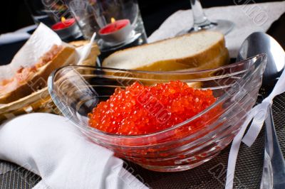 Red caviar in a glass plate 