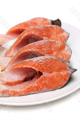 Red fish bit with lemon on plate