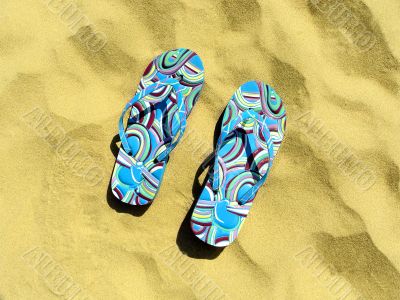 Woman varicoloured schist on yellow sand